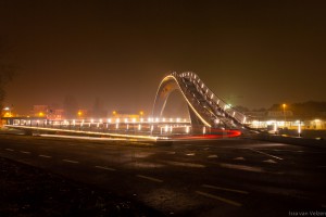 Vooraanzicht van de Melkwegbrug in Purmerend bij nacht. Ook wel bekend als 'De Bochel' Strepen van fietser